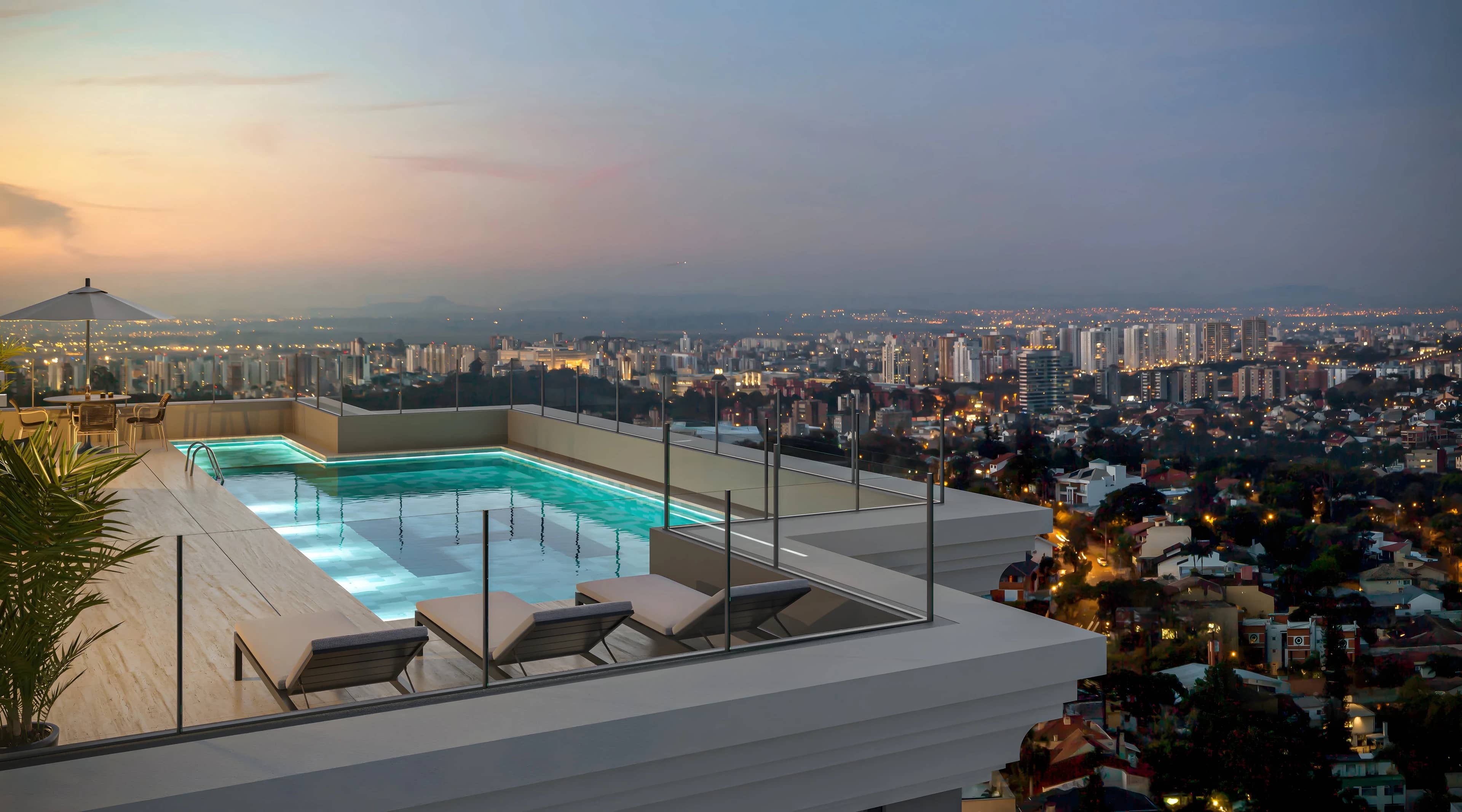 Piscina externa do Harmonic iluminada ao anoitecer