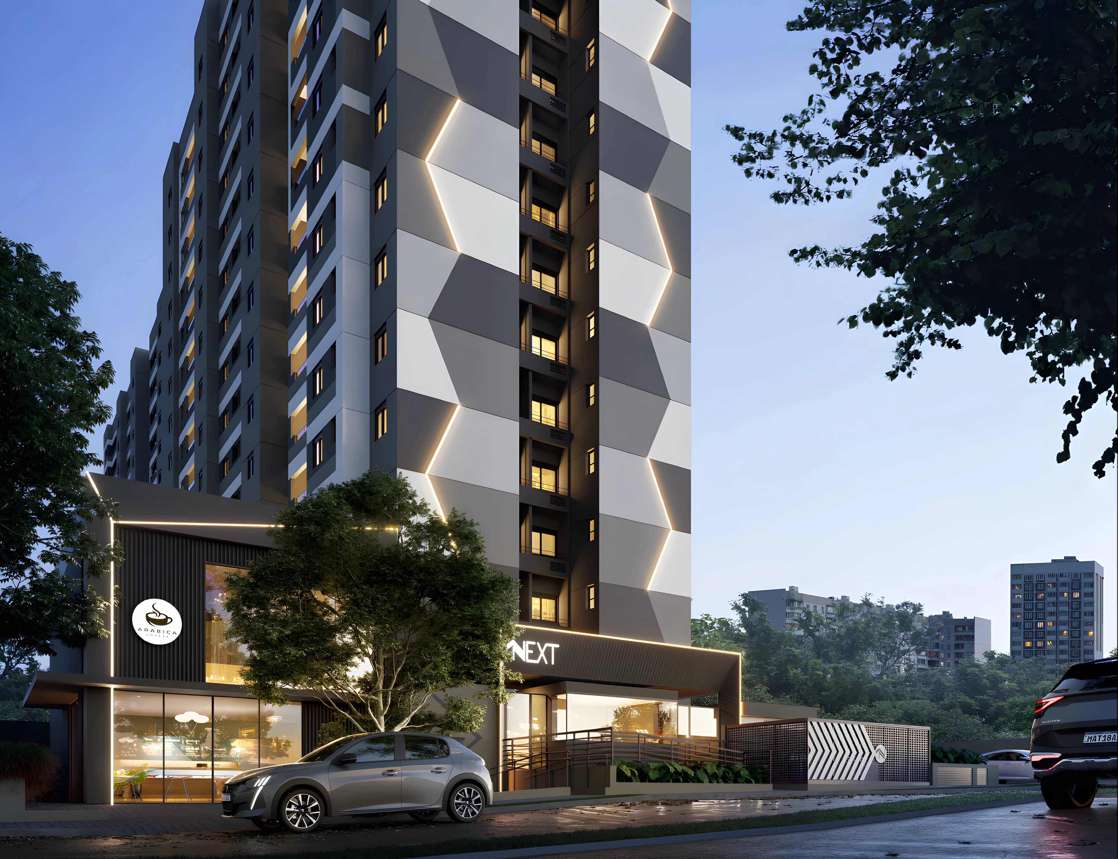 Entrada do Next Home ao anoitecer, com a loja iluminada no térreo e a fachada em losangos cinza e branco